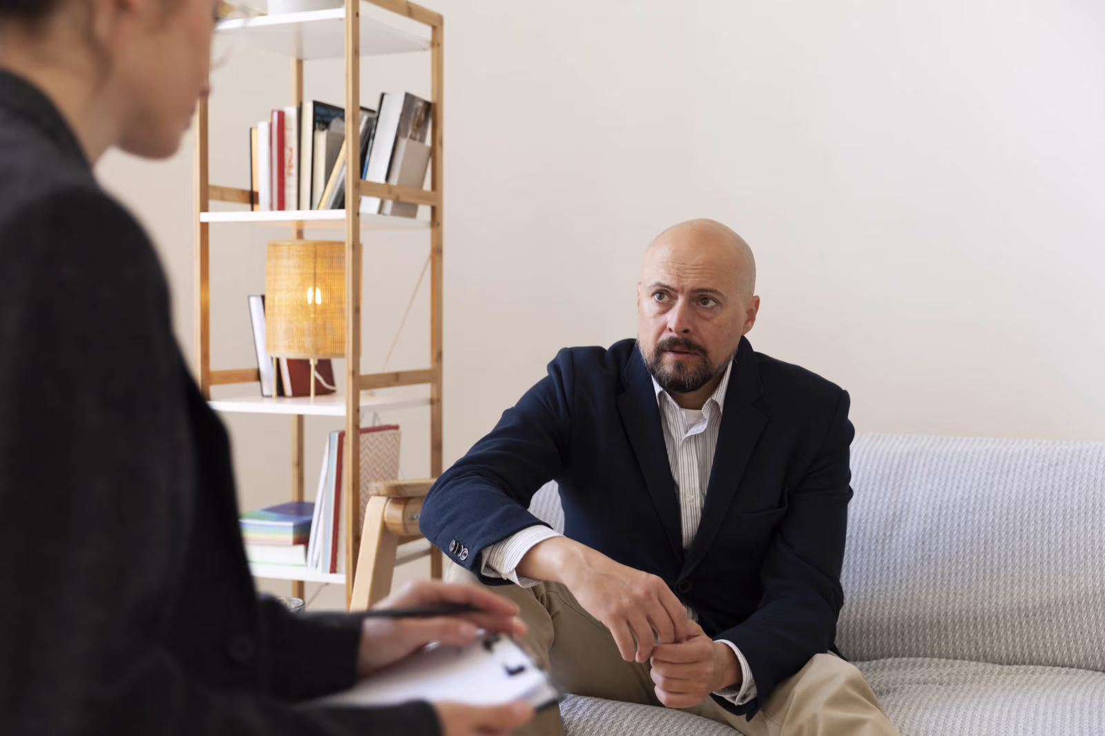 A counselling session in a calm, bright consulting room