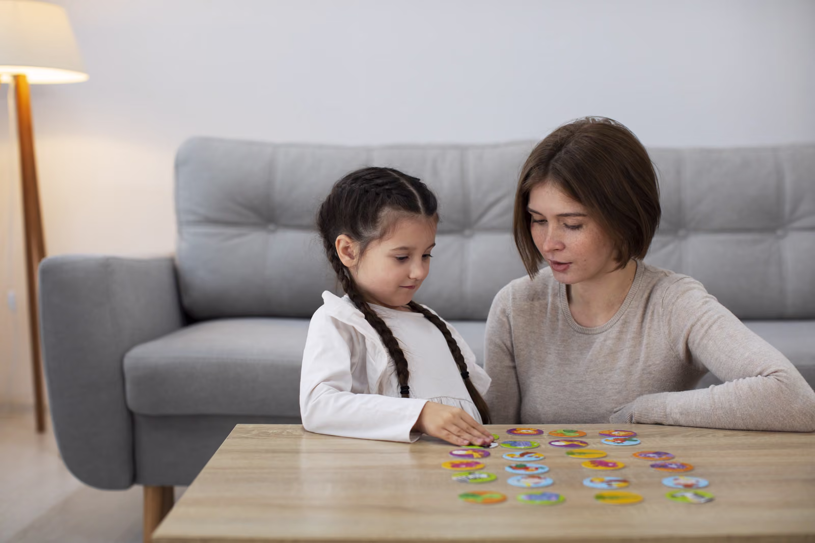 A parent and child playing a game together at home