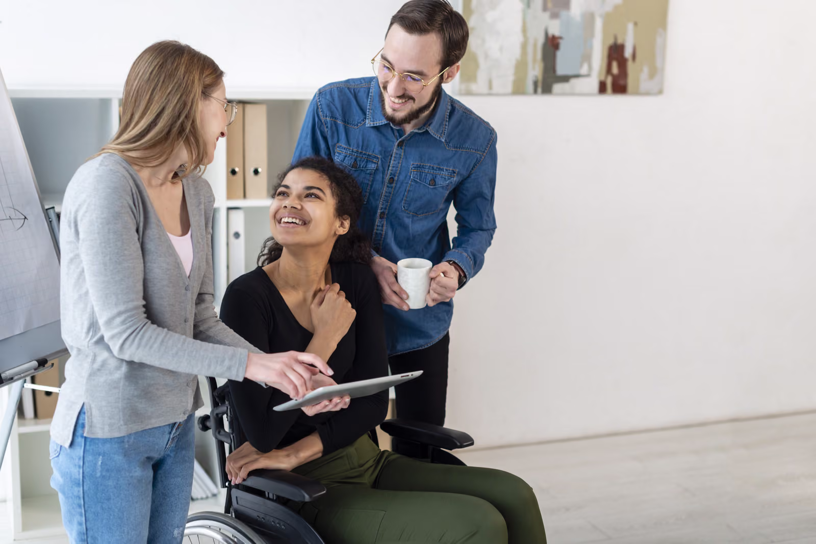 A small group of adults working together on a project in a bright office